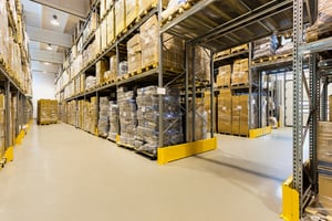 Interior of a huge spacious warehouse with carton boxes-1